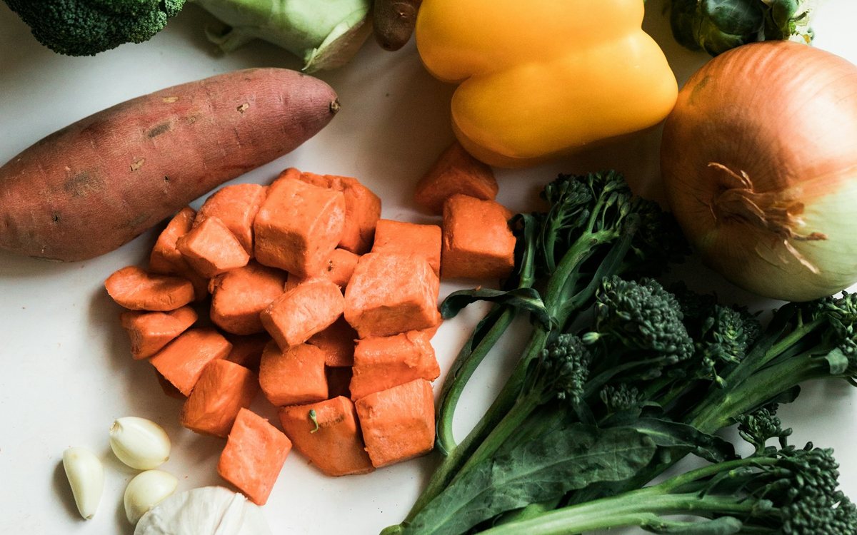 Patates douces, brocolis et autres légumes frais sur une table
